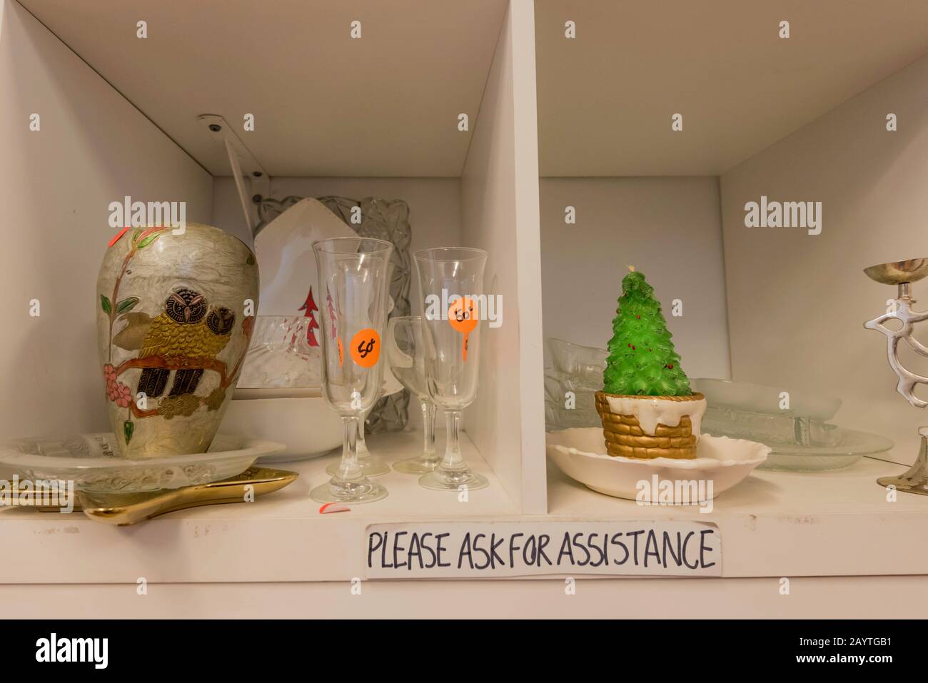 Used glassware, crockery and ornaments on a shelf in a thrift store or charity shop in Brunswick Street, Fitzroy, Melbourne, Australia Stock Photo