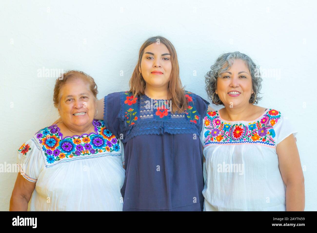 Three generations of latin Mexican women smiling in line, daughter,  grandmother and granddaughter wearing casual clothes looking at the camera  with a Stock Photo - Alamy
