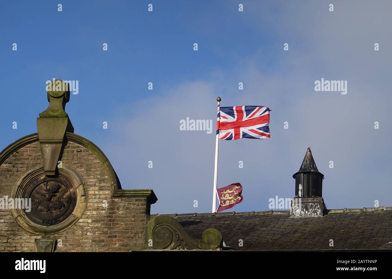 The Union flag and three lions flag on New Mills Town Hall, Derbyshire. Stock Photo