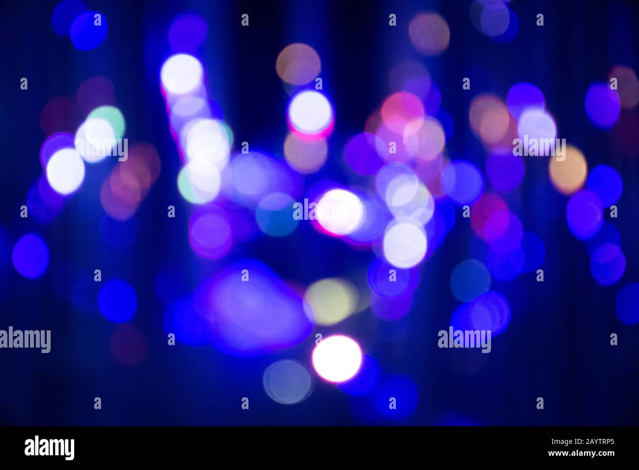 Abstract background with defocused bokeh colorful lights, glowing sparkling lights and reflections Stock Photo
