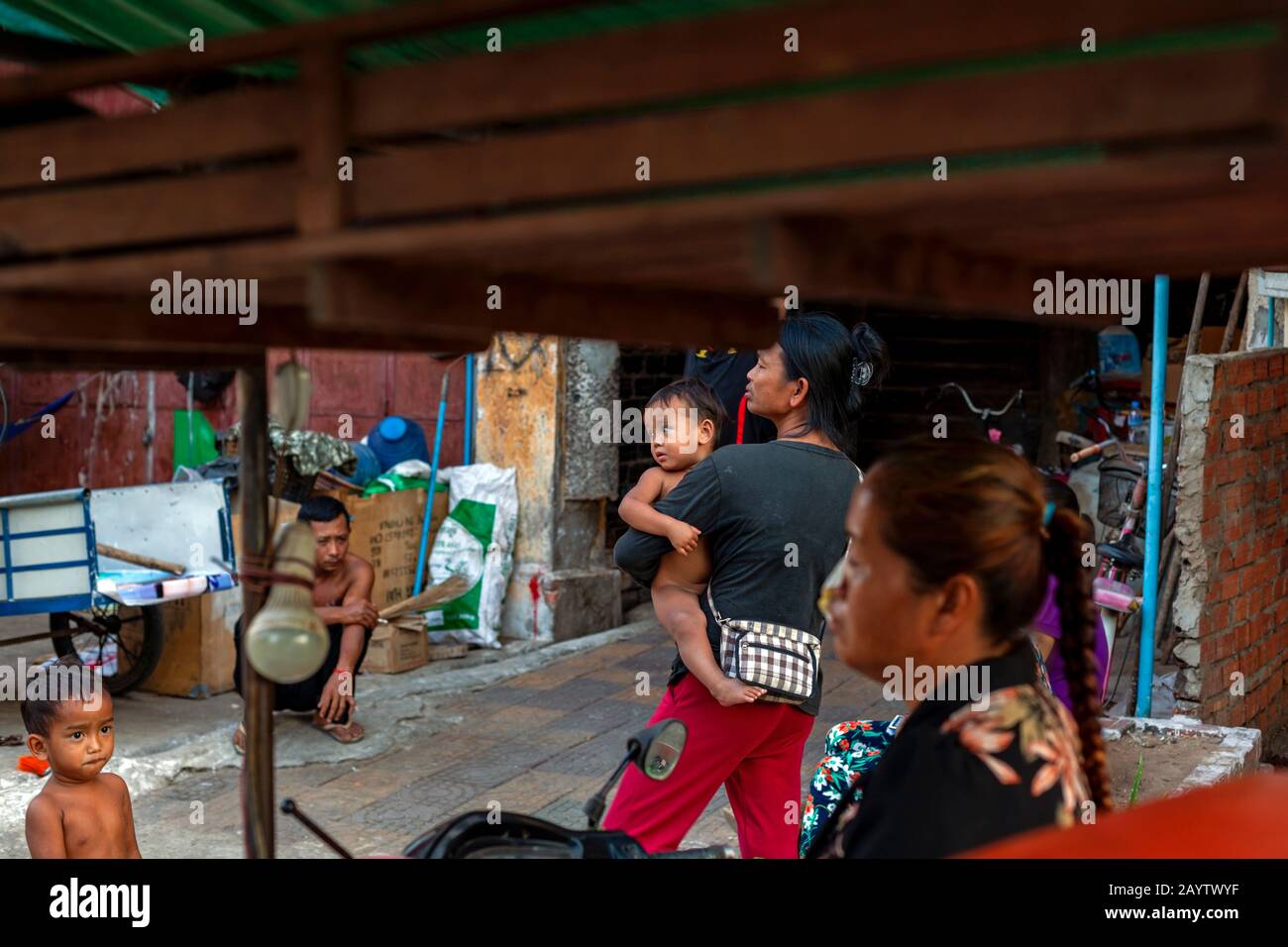 A group of homeless people who earn their livings as garbage scavengers are gathered near their makeshift shelter in Kampong Cham, Cambodia. Stock Photo