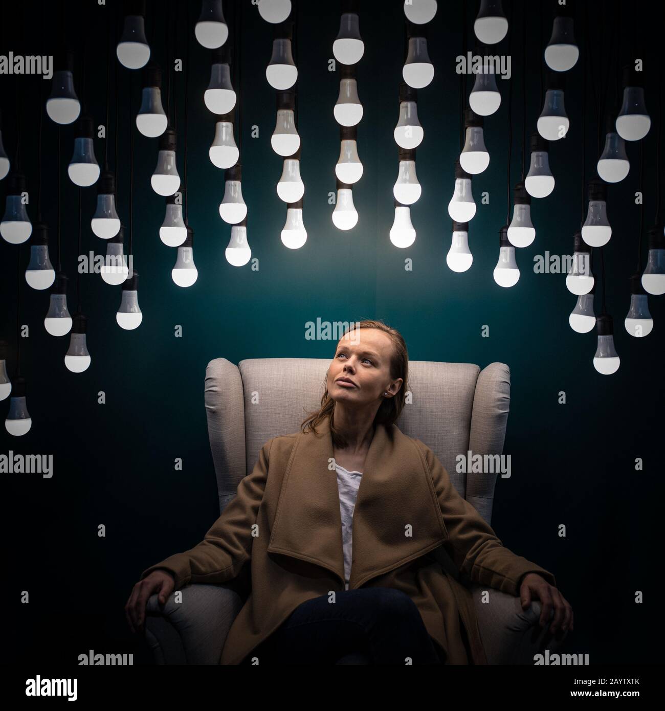 Pretty, young woman having so many ideas for business ventures - light bulb  illumination/eureka moment concept image (color toned image Stock Photo -  Alamy