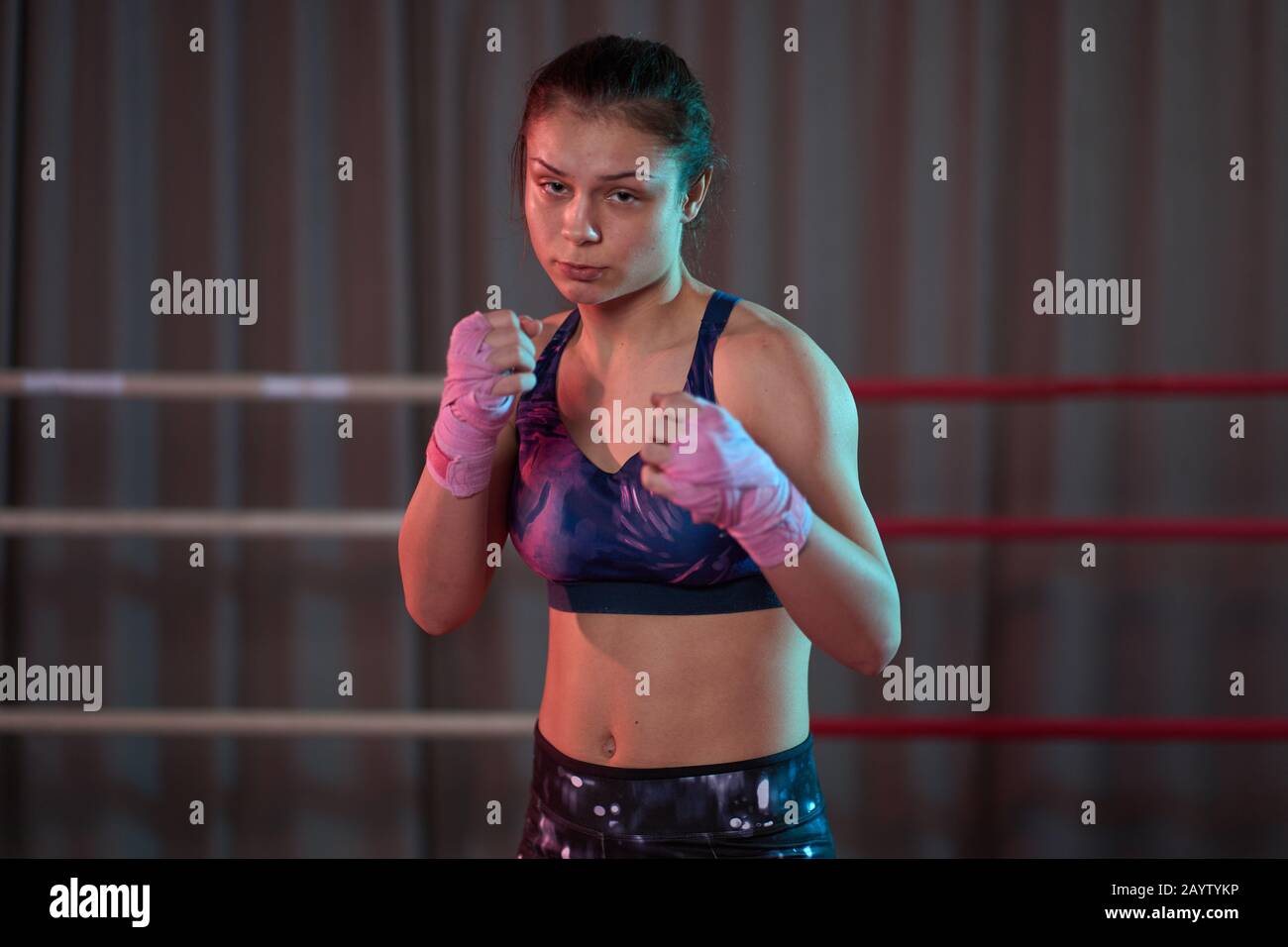 Kickboxer girl shadow boxing in the ring before sparring Stock Photo