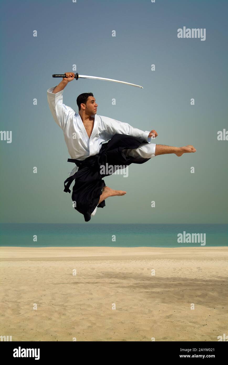 Samurai swordsman jumping  on beach. Stock Photo