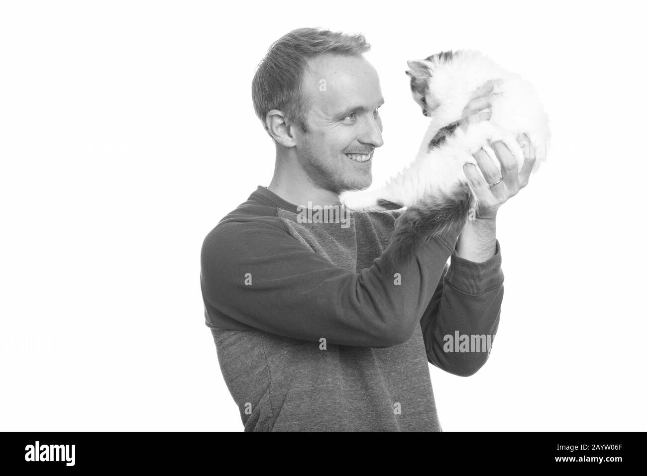 Portrait of happy handsome man holding cute Persian kitten Stock Photo