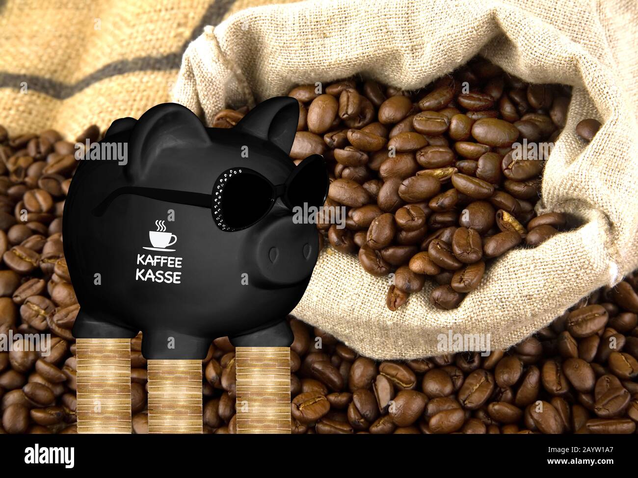 black piggy bank with sun glasses with the lettering Kaffeekasse, kitty, coffee beans and coin stacks in background, composing Stock Photo
