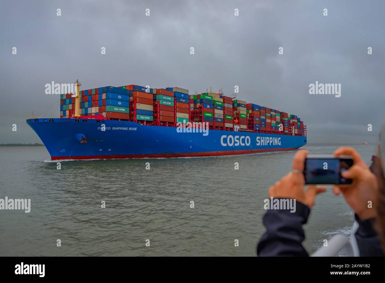 large container ship Cosco Shipping on the Elbe photographed with a smart phone, Germany, Schleswig-Holstein Stock Photo