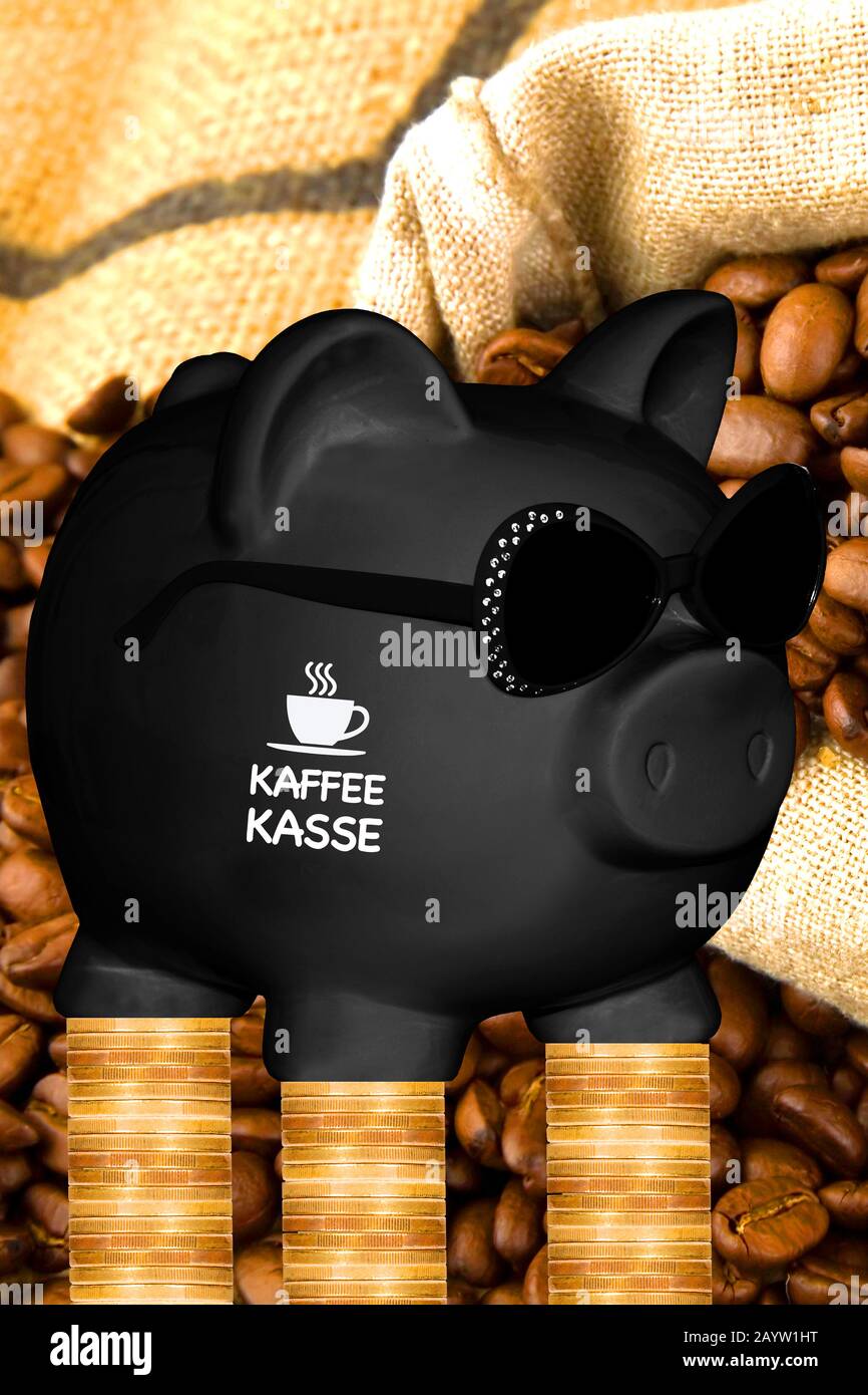 black piggy bank with sun glasses with the lettering Kaffeekasse, kitty, coffee beans and coin stacks in background, composing Stock Photo