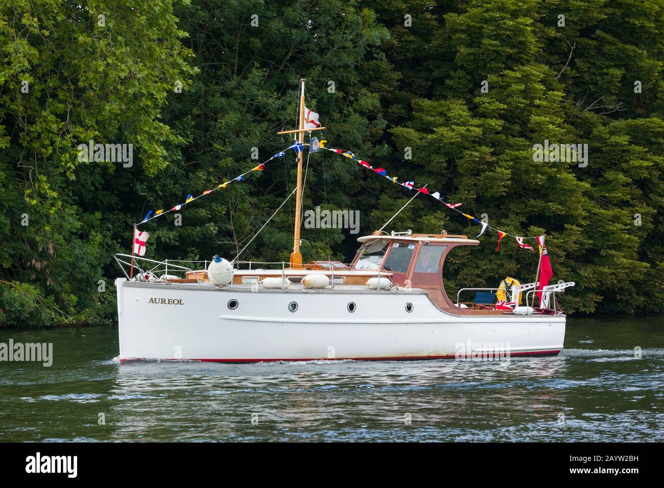 The classic 1935 Dunkirk Little Ship 'Aureol' on the Thames near Henley-on-Thames with bunting and flags Stock Photo