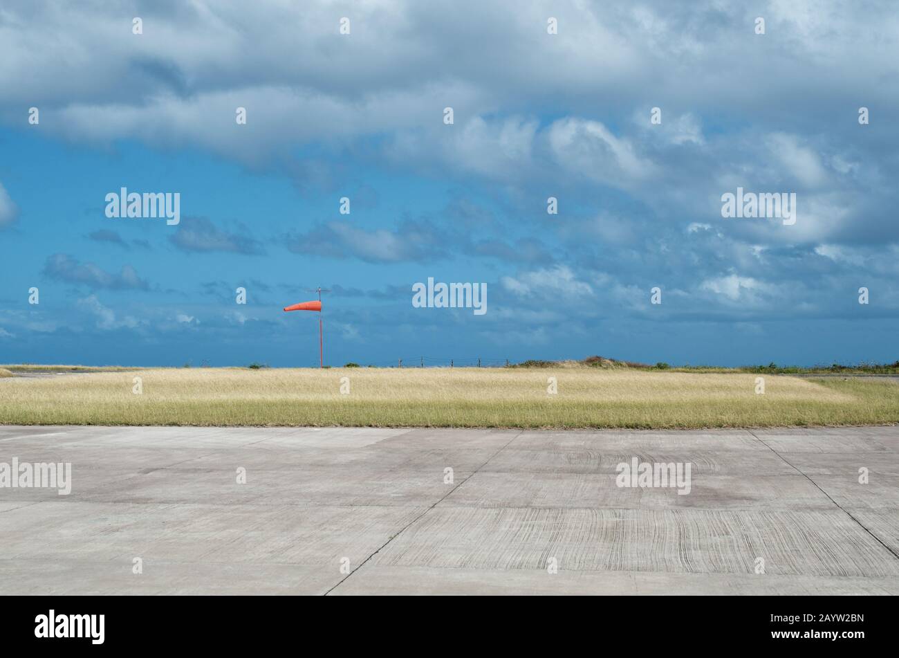 Small airport landing strip with orange wind indicator. Juancho E. Yrausquin Airport, Saba. IATA: SAB. Stock Photo