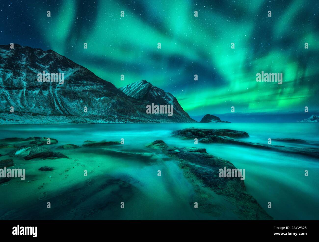Aurora borealis over snowy mountains, sea coast with sandy beach Stock ...
