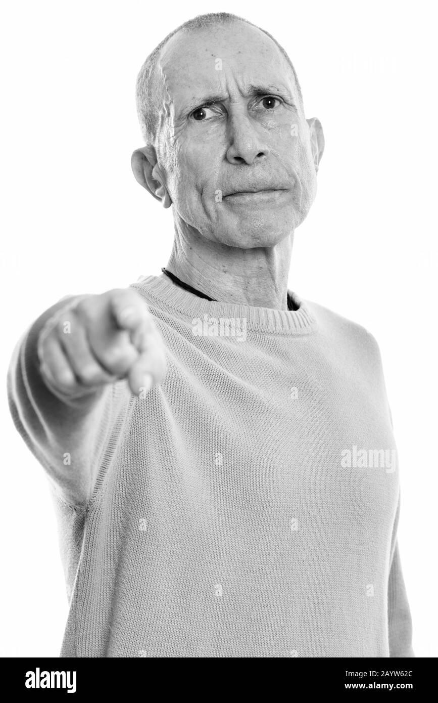 Studio shot of angry senior man pointing finger at camera Stock Photo