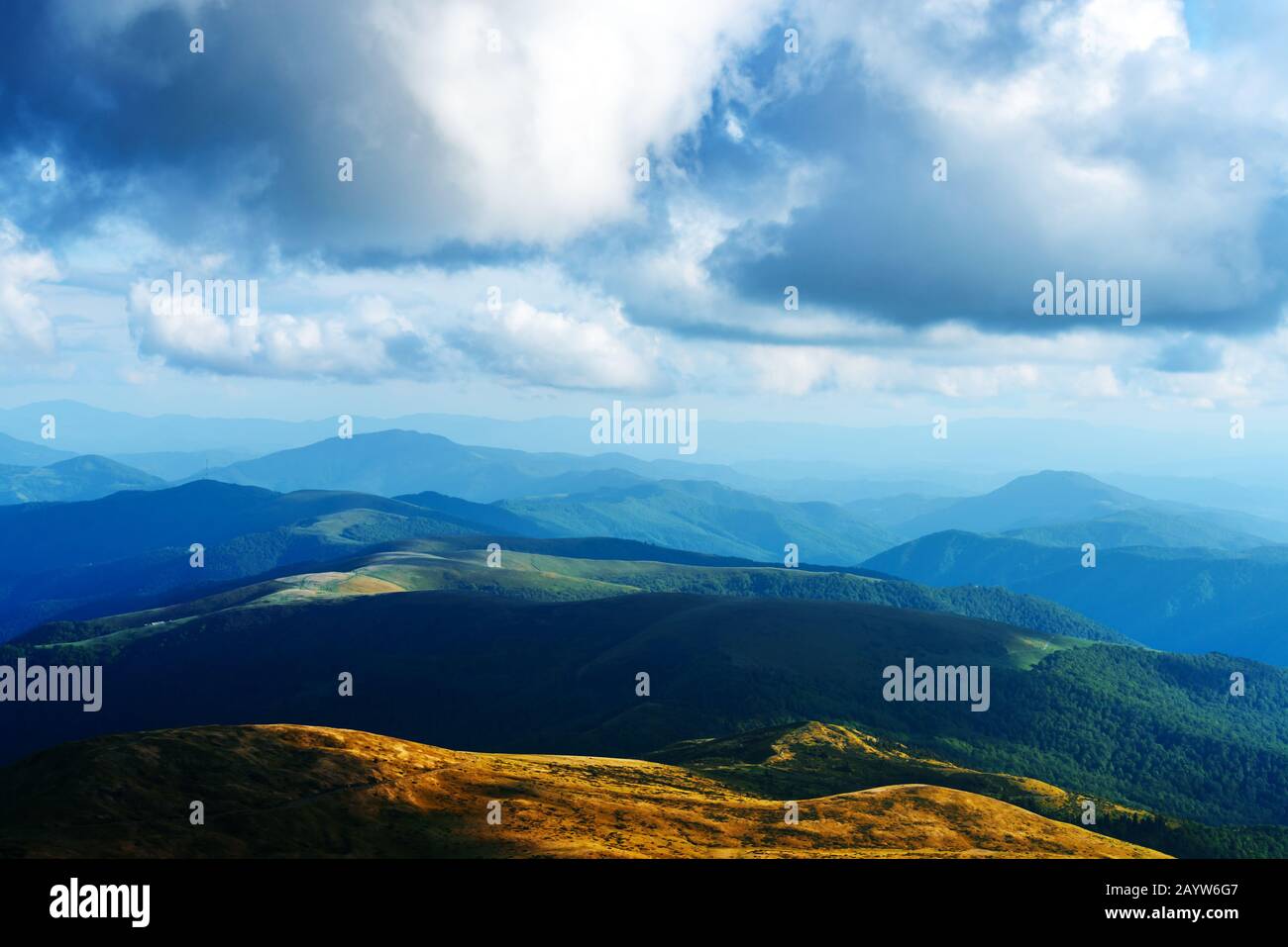 Incredible view of the blue hills glowing by evening sunlight. Dramatic scene with summer mountains. Landscape photography Stock Photo