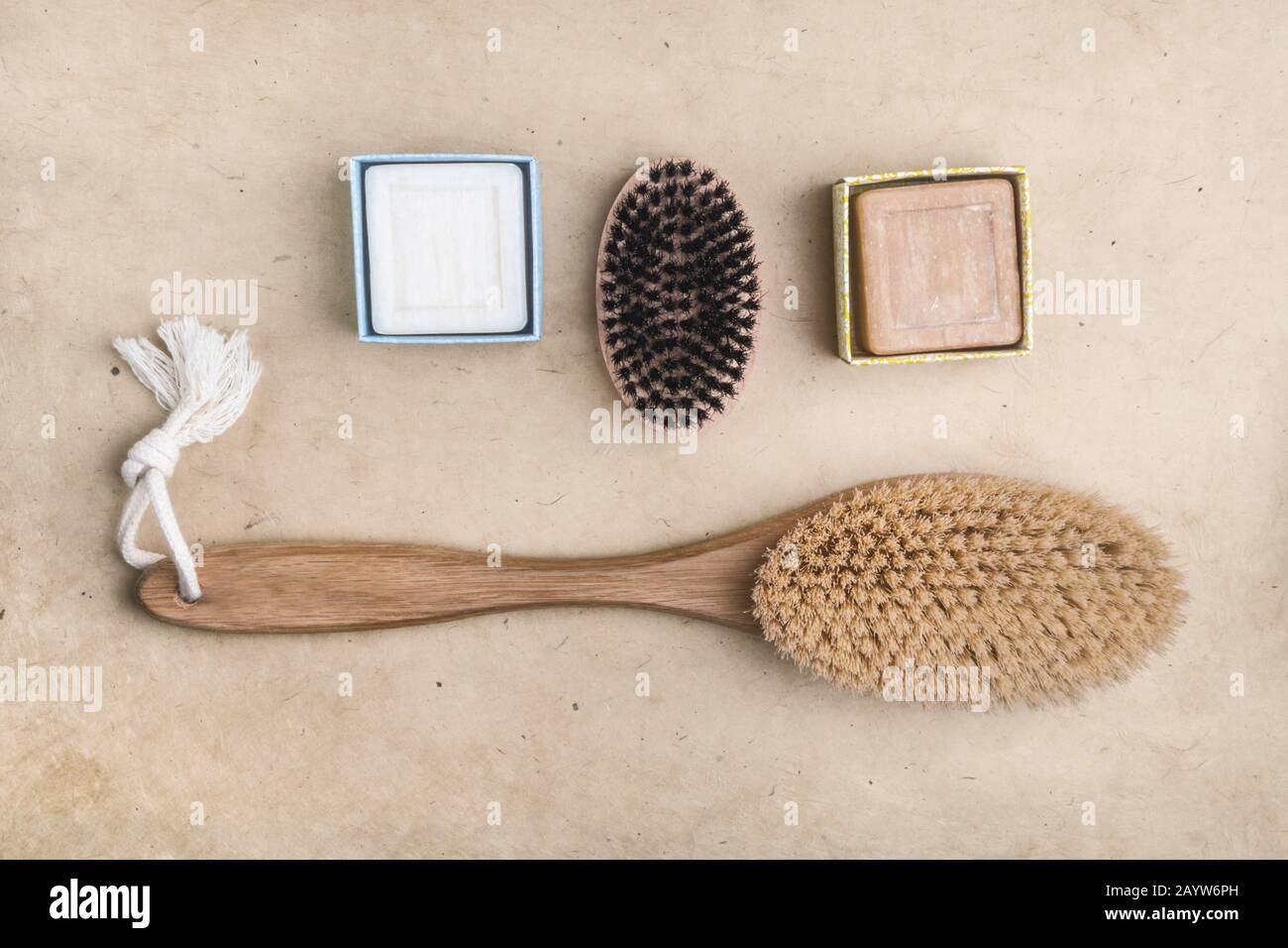 Beauty and skin care. Closeup spa products bath accessories scrub brush, homemade soap on wooden table. Stock Photo