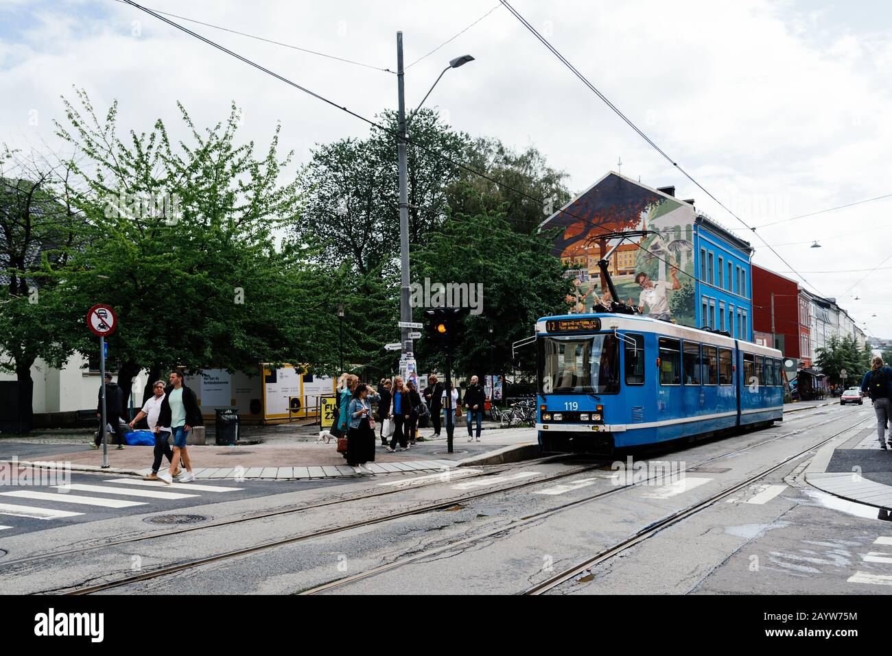 Oslo, Norway - August 11, 2019: Blue tram speeding up in Grunerlokka, a trendy hipster neighborhood in central Oslo. Summer rain Stock Photo