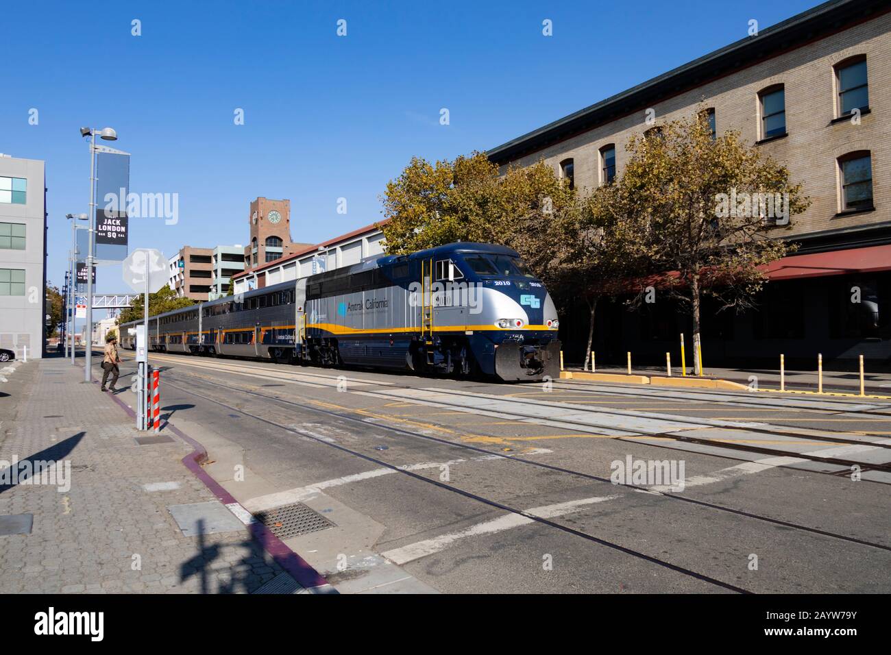 Amtrak EMD CDTX 2010 diesel locomotive passes along Embarcadero West,  Jack London Square, Oakland, California, USA Stock Photo