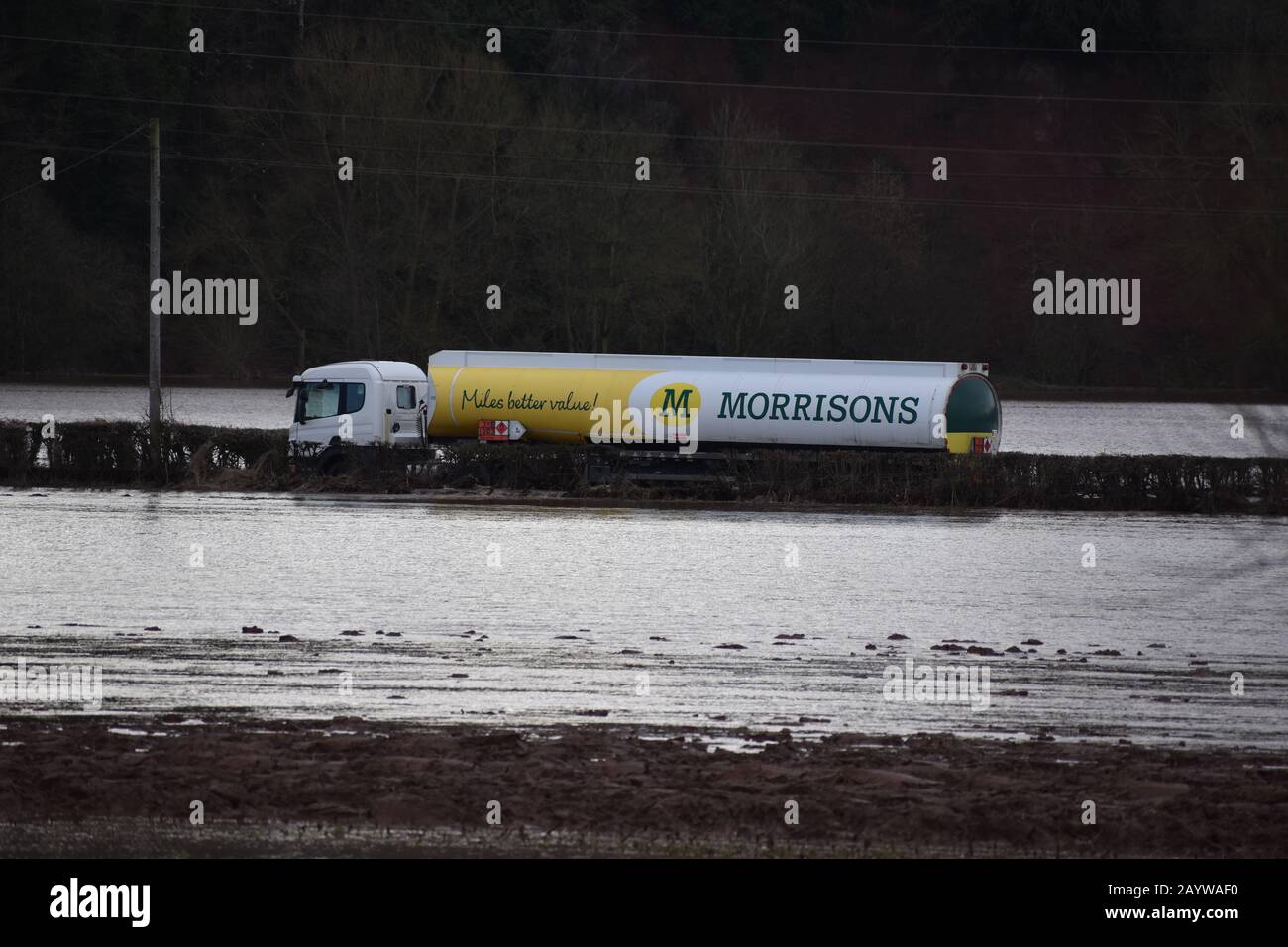 An abandoned fuel tanker stranded in floodwater caused by Storm Dennis on a road running alongside the River Teme near near Tenbury Wells, Worcestershire. Local people said the tanker had been stuck near Eastham since Saturday. Stock Photo