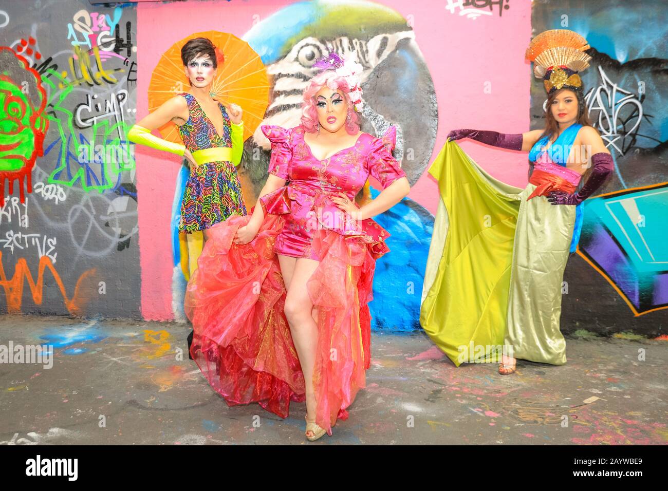 Waterloo, London, 17th Feb 2020. Drag collective Bitten Peach (ShayShay with umbrella, Lilly Snatchdragon in pink dress and wig, and Evelyn Carnate, in blue top) go underground in the graffiti-clad tunnels in Waterloo to celebrate London's VAULT Festival. The festival has returned for its eighth year with eight weeks of the best new theatre and comedy, immersive experiences, cabaret, live performance and late-night parties. VAULT Festival runs until March 22nd. Credit: Imageplotter/Alamy Live News Stock Photo