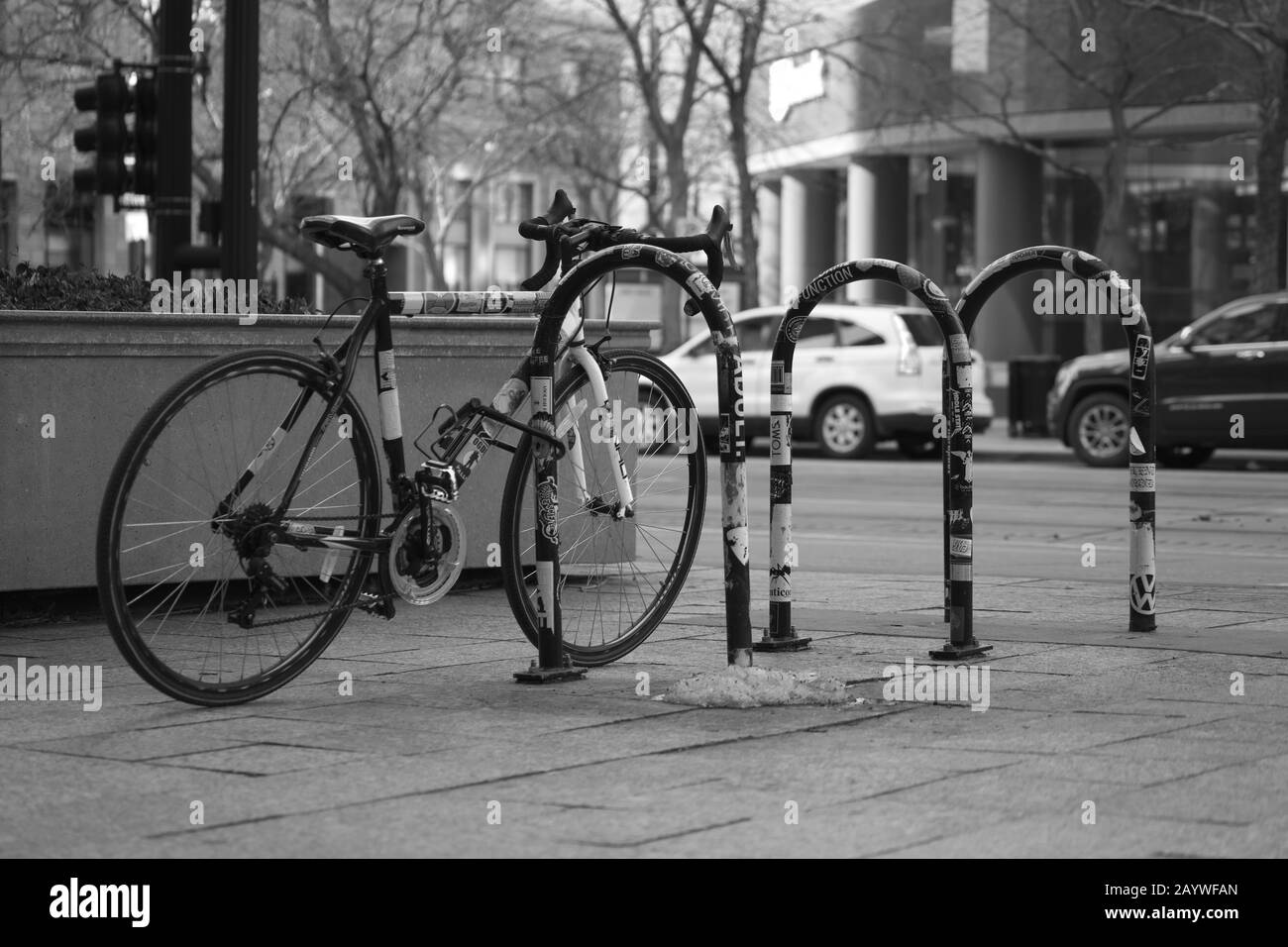 Bicycle secured on a bike rack in the city. Stock Photo