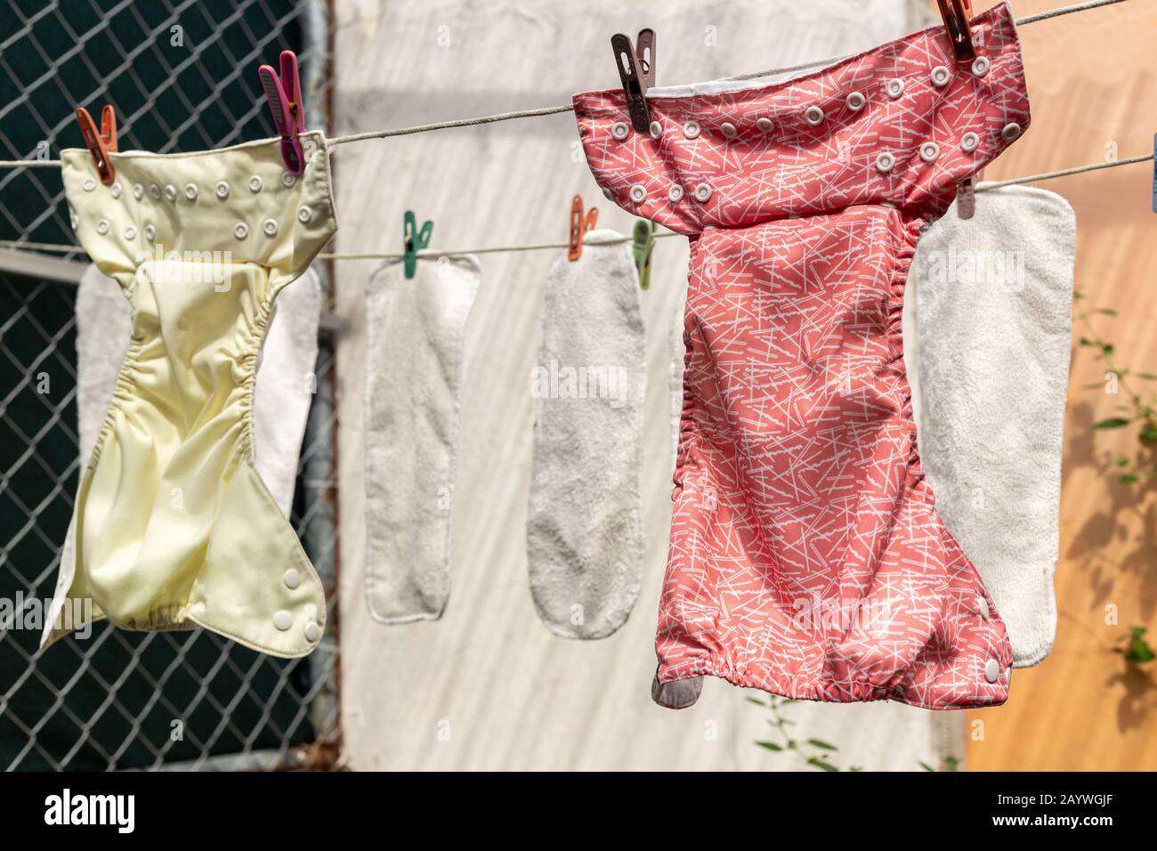 Washed cloth diapers hanging outside on a clothesline to dry in the sun  Stock Photo - Alamy