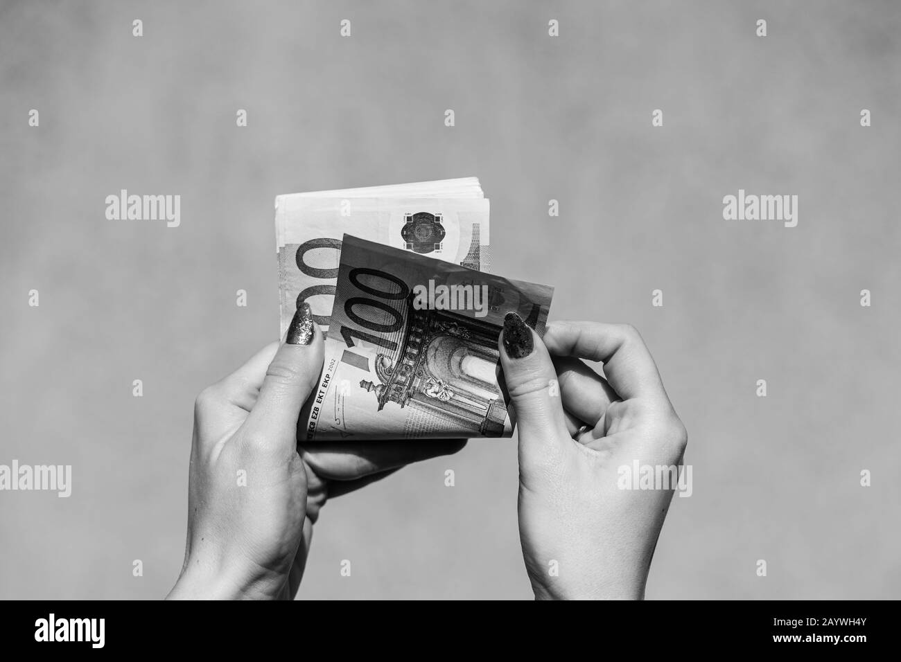 Hand couting holding and showing euro money or giving money. World money concept, 100 EURO banknotes EUR currency isolated with copy space. Concept of Stock Photo