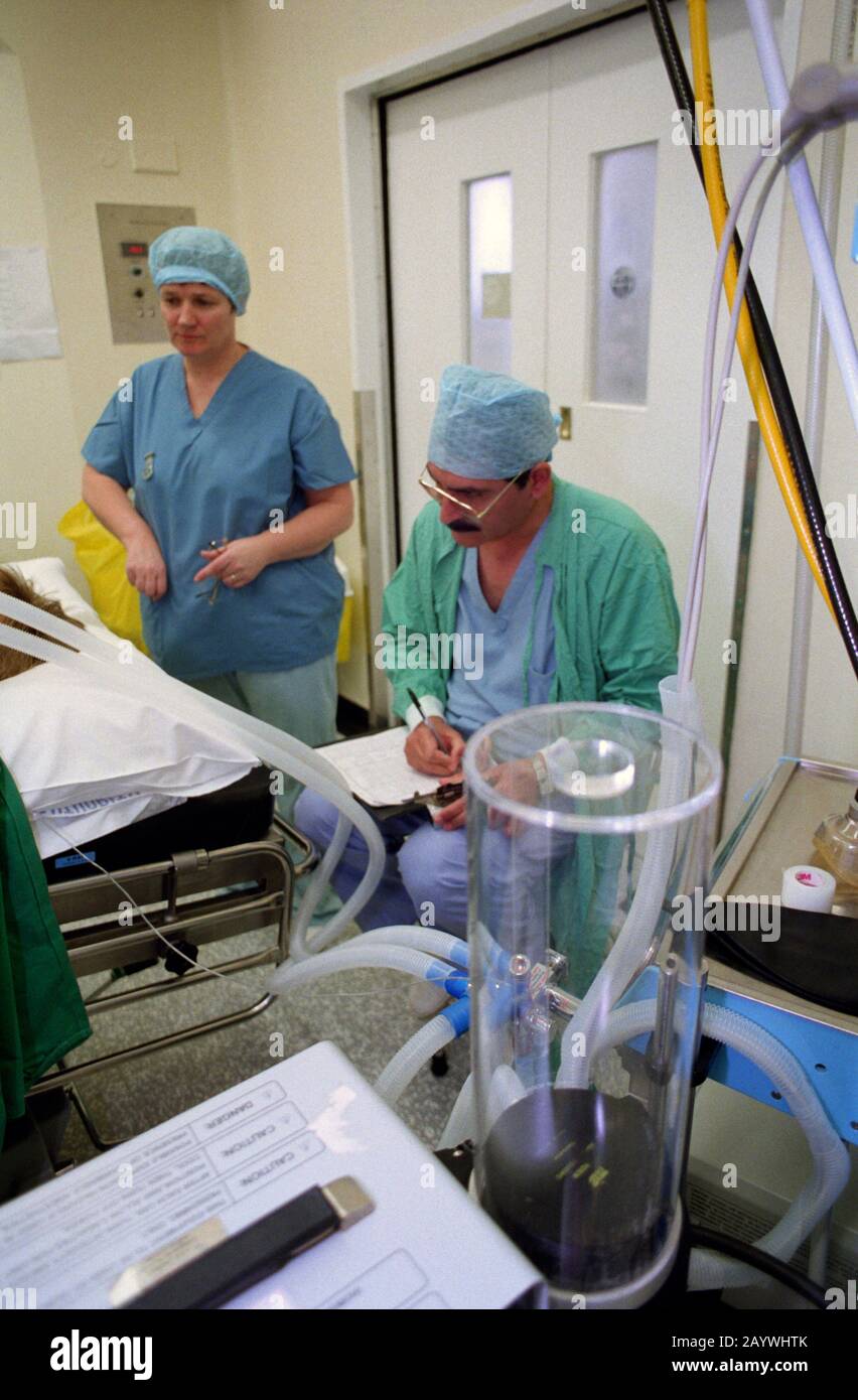 Anaesthetist monitoring patients vital signs during surgery Stock Photo
