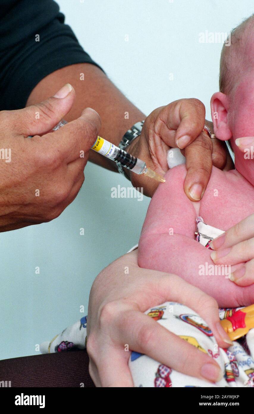 Baby having its first DTP/polio/Hib immunisation Stock Photo