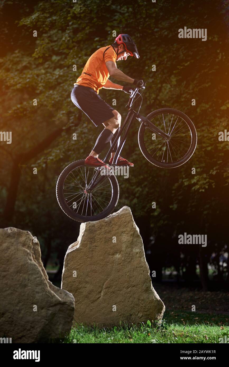 Extreme show of talented trail biker performing on big rocks standing ...