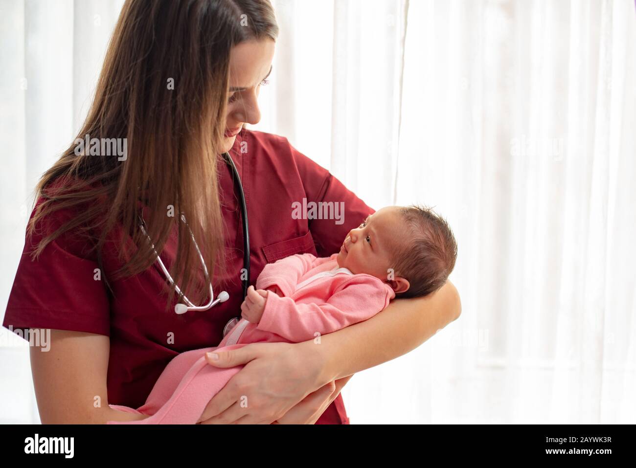 Pediatrician holding a beautiful newborn baby girl Stock Photo