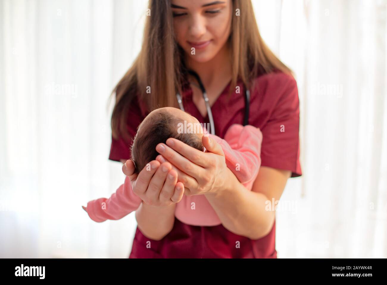 Pediatrician holding a beautiful newborn baby girl Stock Photo