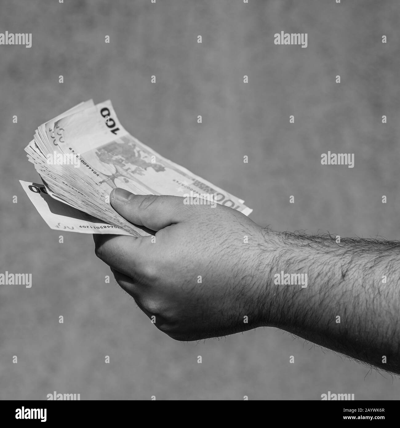 Hand holding and showing euro money or giving money. World money concept, 100 EURO banknotes EUR currency isolated. Concept of rich business people, s Stock Photo