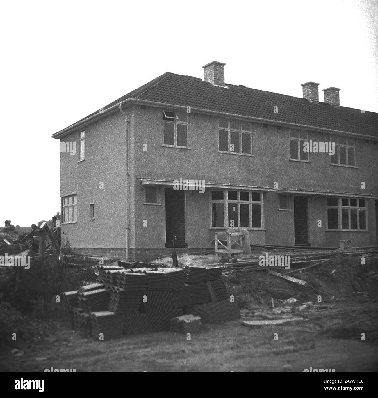 1950s, historical, post-war and new semi-detached houses with a pebble-dash exterior being built, England, UK, showing an end of terrace house. Stock Photo