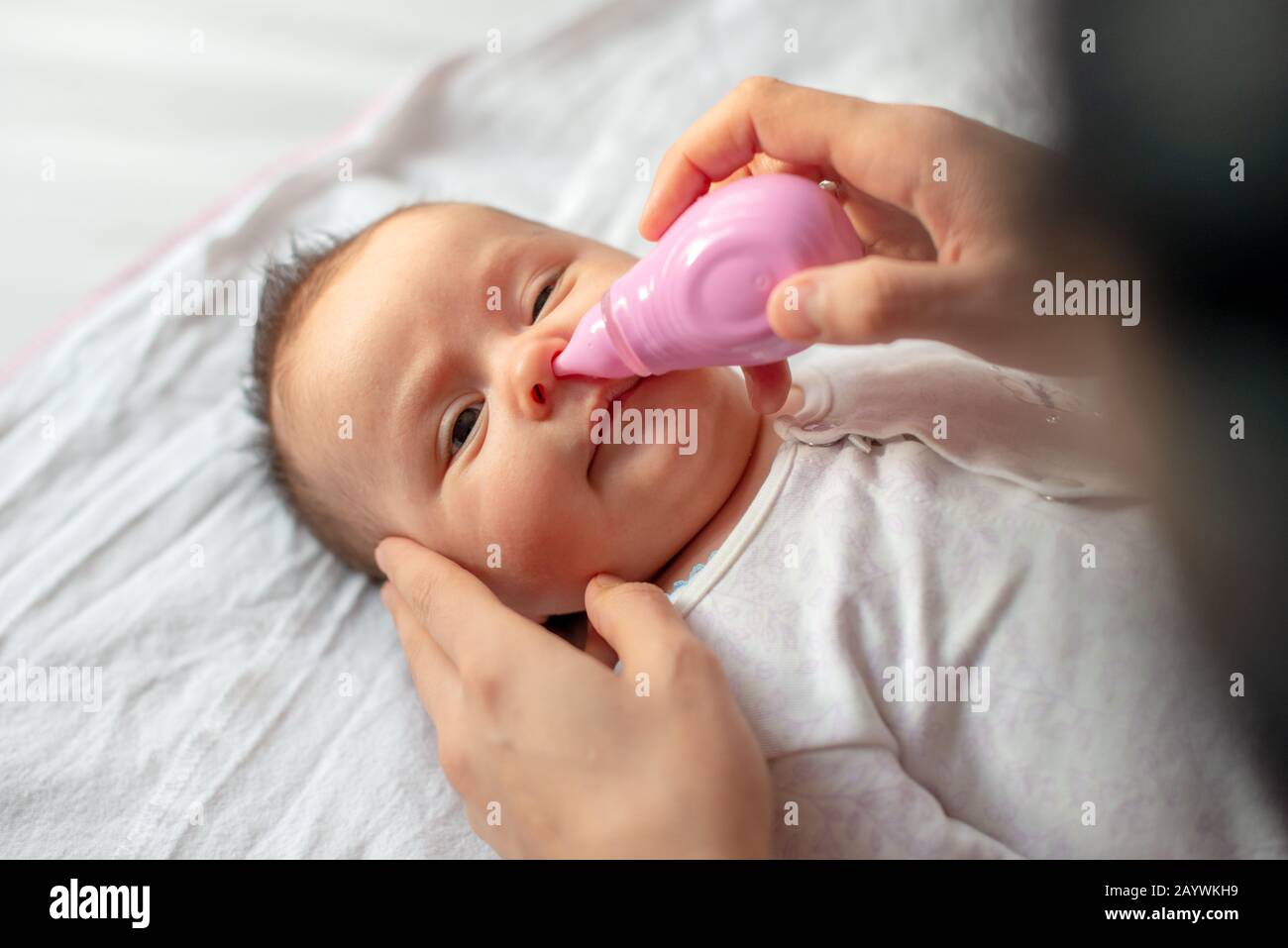 https://c8.alamy.com/comp/2AYWKH9/mother-using-baby-nasal-aspirator-mucus-nose-suction-2AYWKH9.jpg