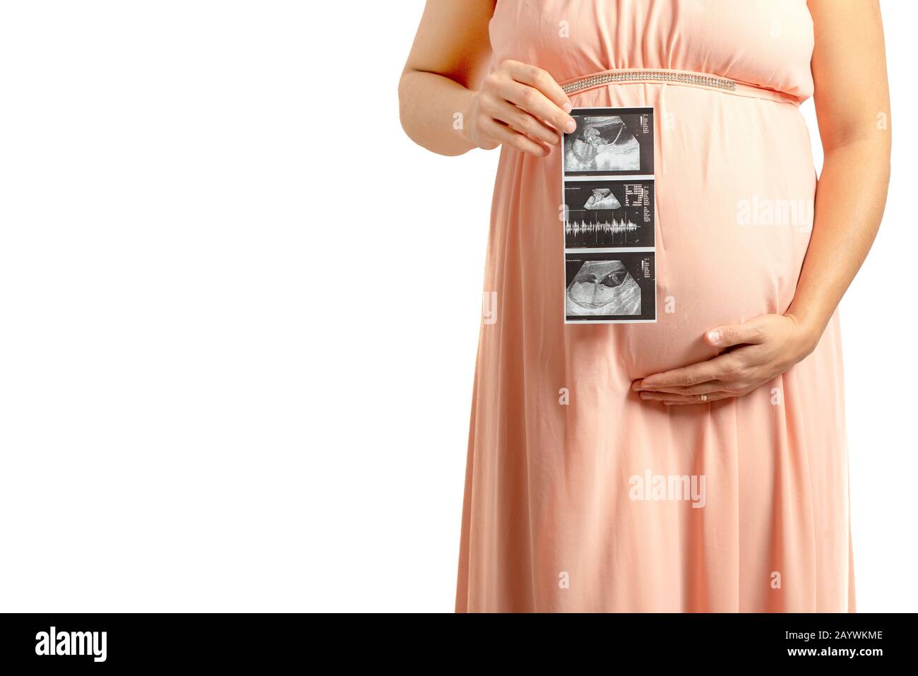 pregnant women holding props with baby ultrasound image on it . Indoor maternity shoot with props on white background. Stock Photo