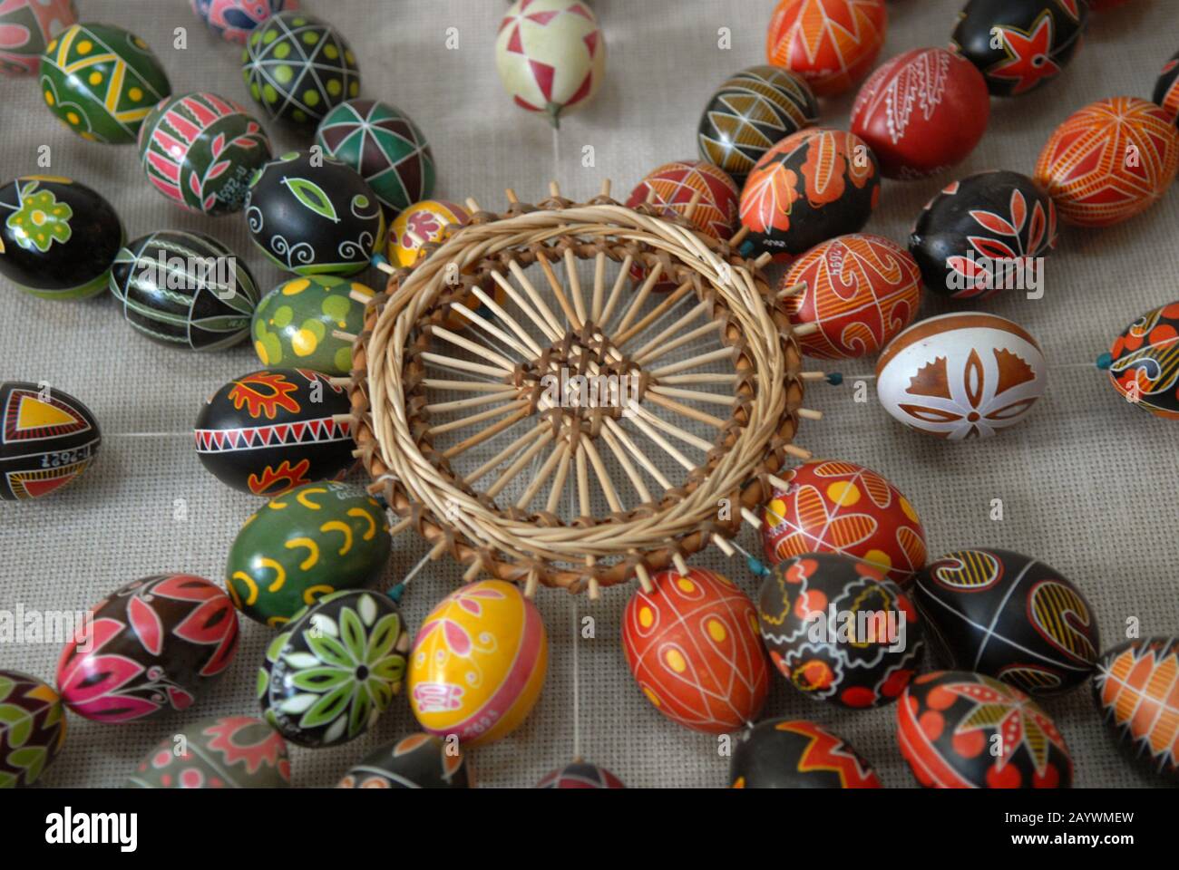 Easter composition - Pysankas (decorated eggs) and crafts made of straw. Kolomyia. Stock Photo