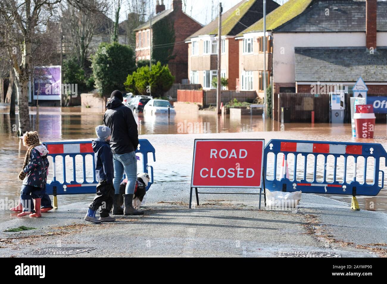 Hereford, Herefordshire, UK - Monday 17th February 2020 - A young family stops to view the flooding along the Ledbury Road area of the city which includes a flooded Texaco fuel station.  Photo Steven May / Alamy Live News Stock Photo