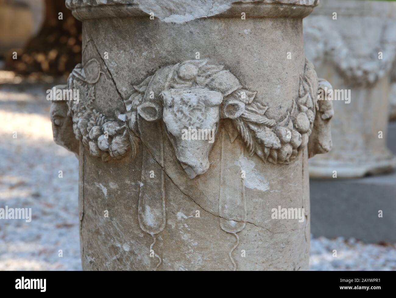 Well-head (classical puteal). Decorated with reliefs of bulls'heads with garlands. Castle of Bodrum. Turkey. Stock Photo