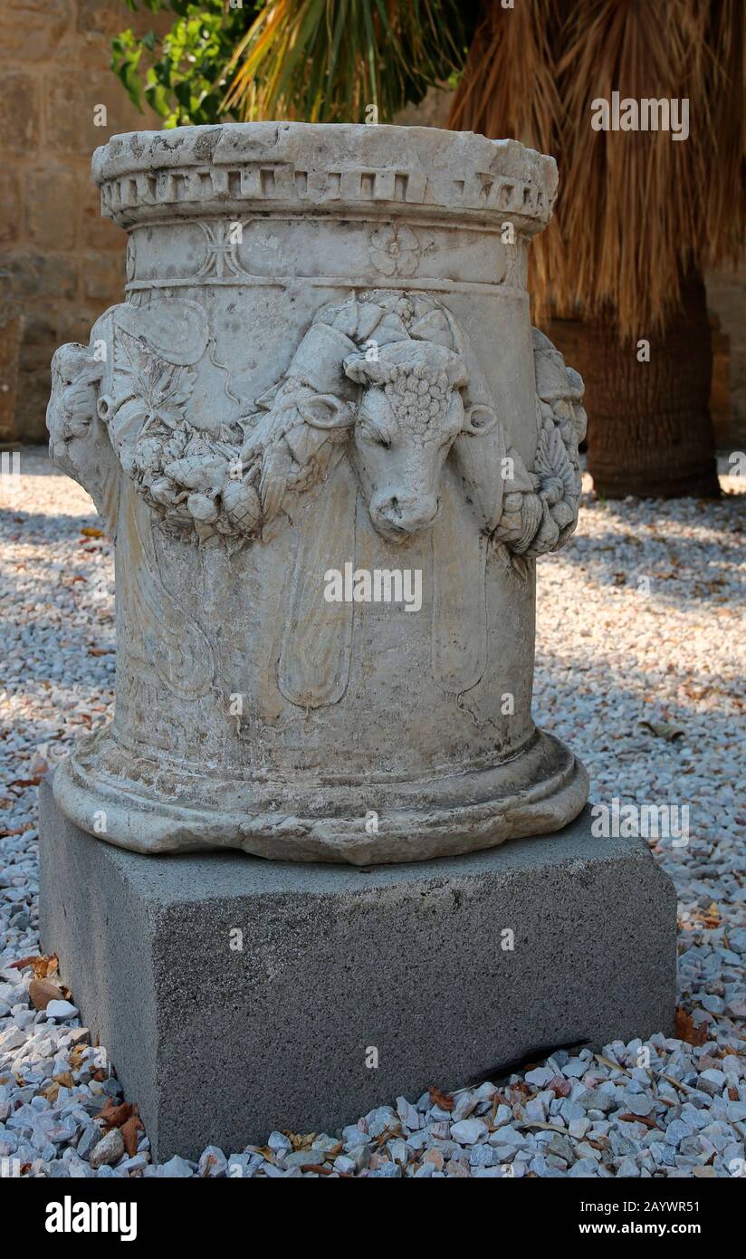 Well-head (classical puteal). Decorated with reliefs of bulls'heads with garlands. Castle of Bodrum. Turkey. Stock Photo
