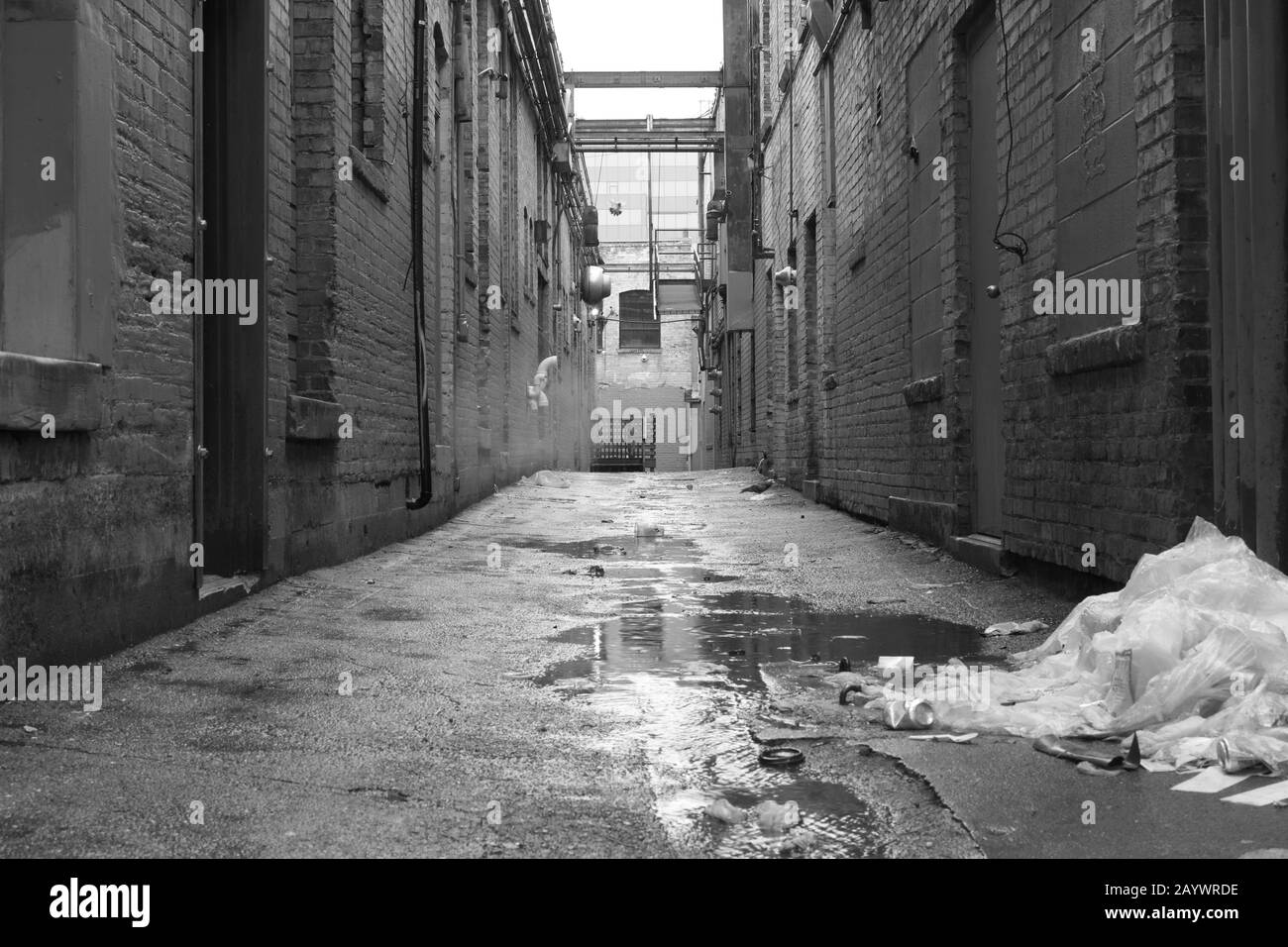 Filthy alley in a rainy urban environment (black and white) Stock Photo