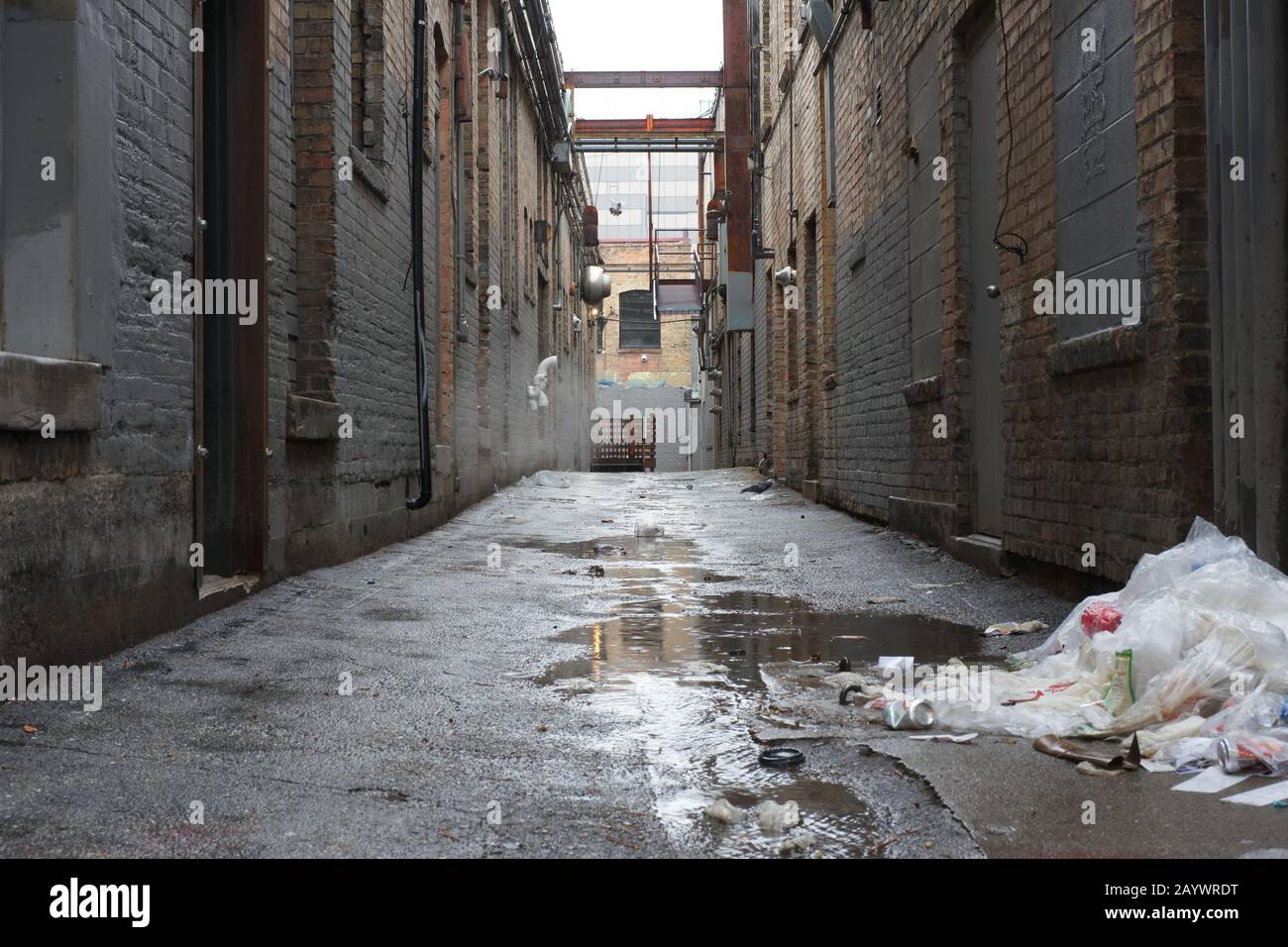 Filthy alley in a rainy urban environment (black and white) Stock Photo