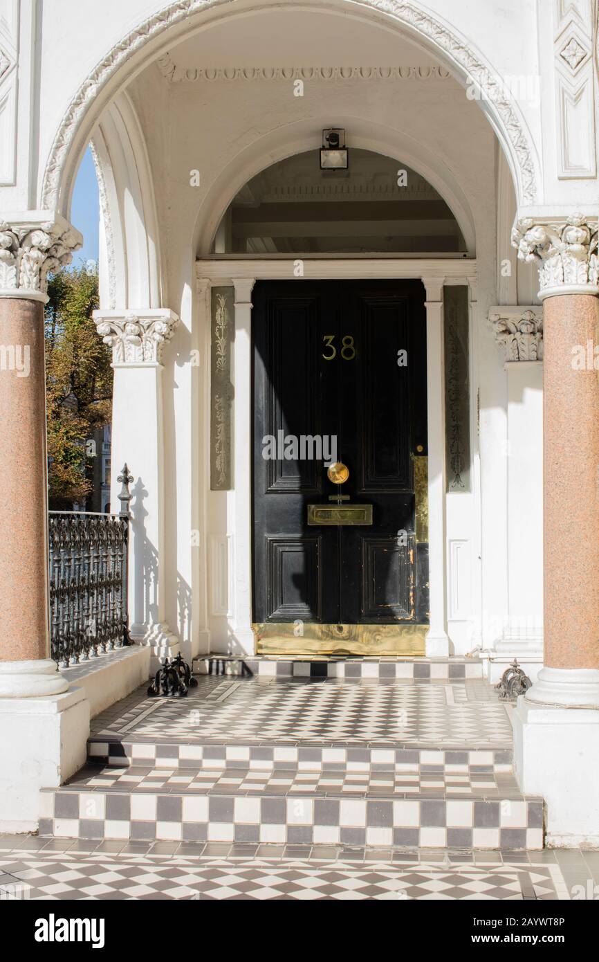 Wellappointed doorway with blackandwhite tiled floor of entrance to