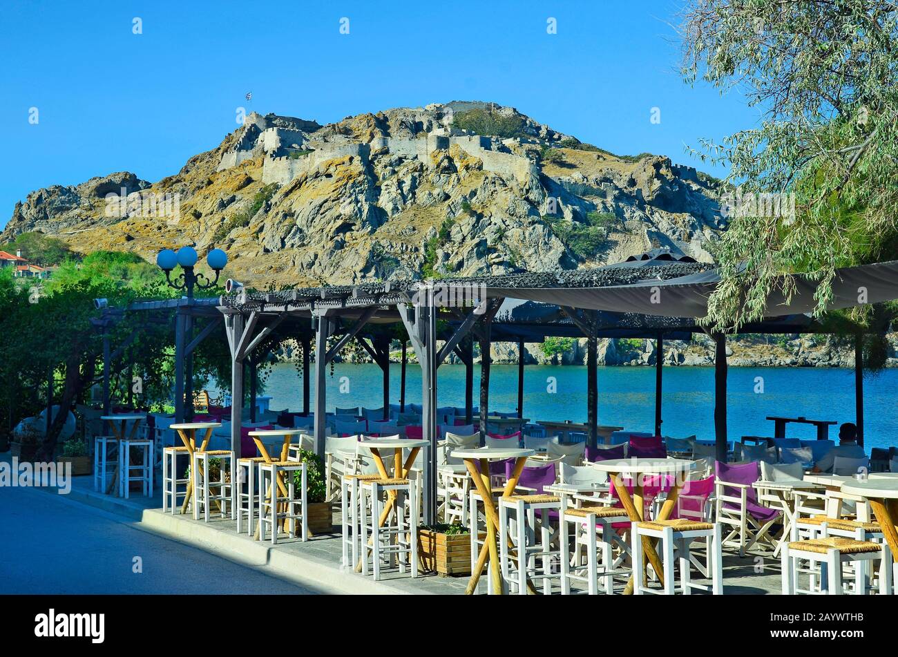 Greece, fortress of Myrina on Lemnos Island with restaurants on promenade Stock Photo