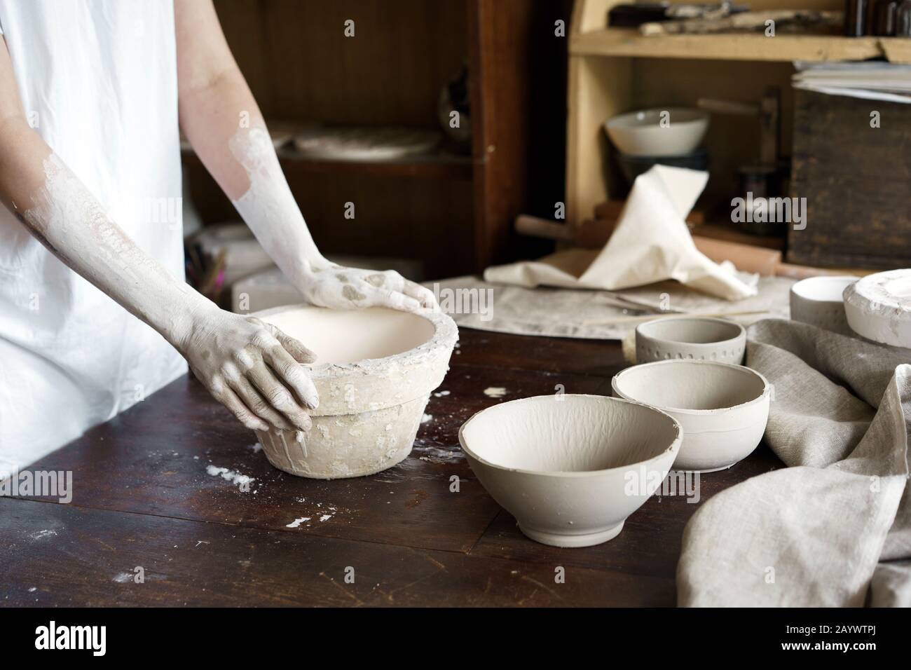 Female hands hold a bowl for casting clay products.  Stock Photo