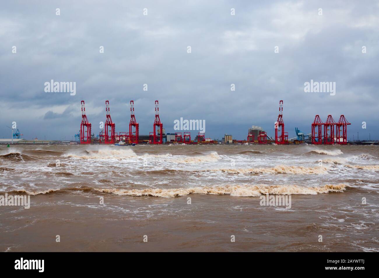Looking across the river towards the cranes at Liverpool 2 from New Brighton Merseyside during the recent Storm Ciara. Stock Photo