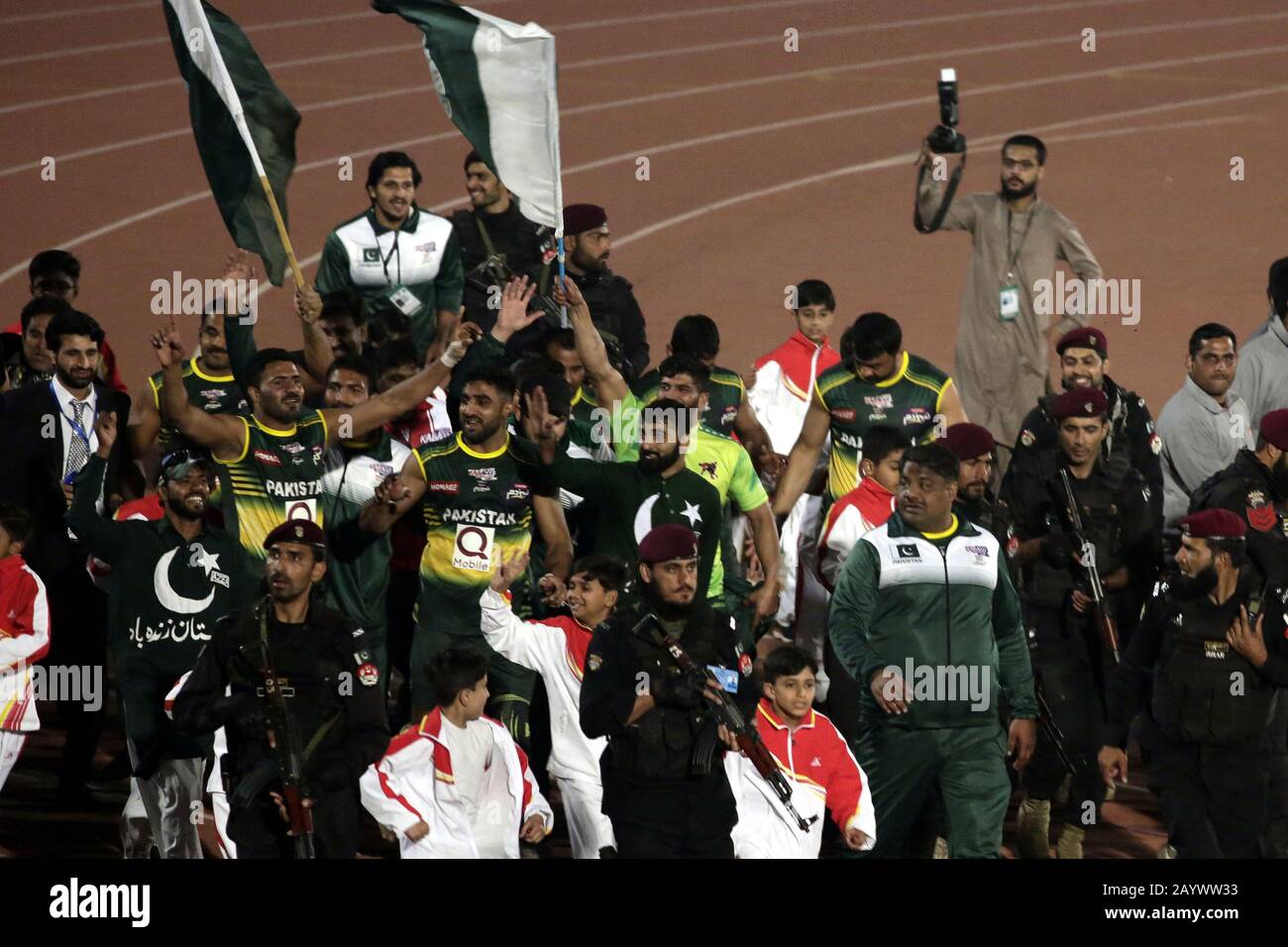 Pakistani Kabaddi team's players wave Pakistan national flags and spectators are celebrating its victory after winning final match of Kabaddi World Cup 2020, as Pakistan won the kabaddi world-cup 2020 by 2 points scoring 43-41 for the first time at Punjab Stadium in Lahore. (Photo by Rana Sajid Hussain/Pacific Press) Stock Photo