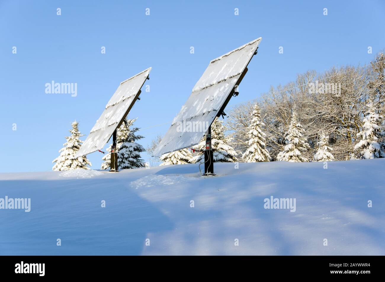 Heavy snow melting and falling off photovoltaic solar panels Stock