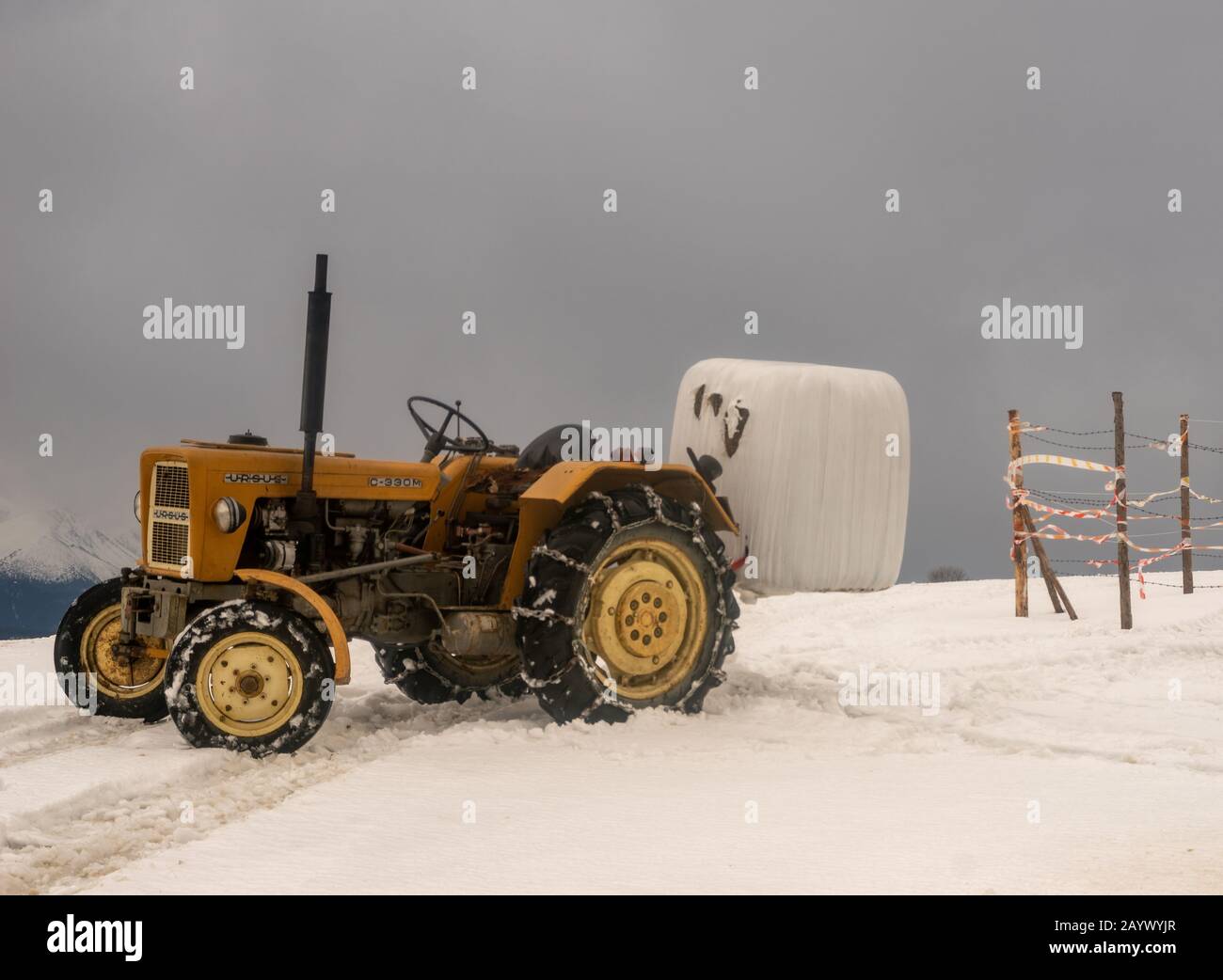 Agricultural tractor 'Ursus' C330 while working in winter mountain scenery. Tatra Mountains, Poland Stock Photo