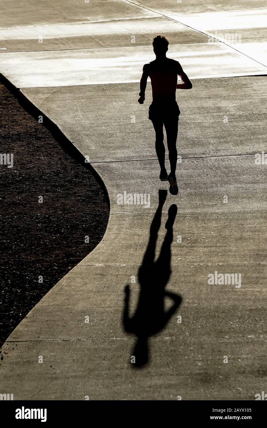 Silhouette of a runner from a high angle. Stock Photo