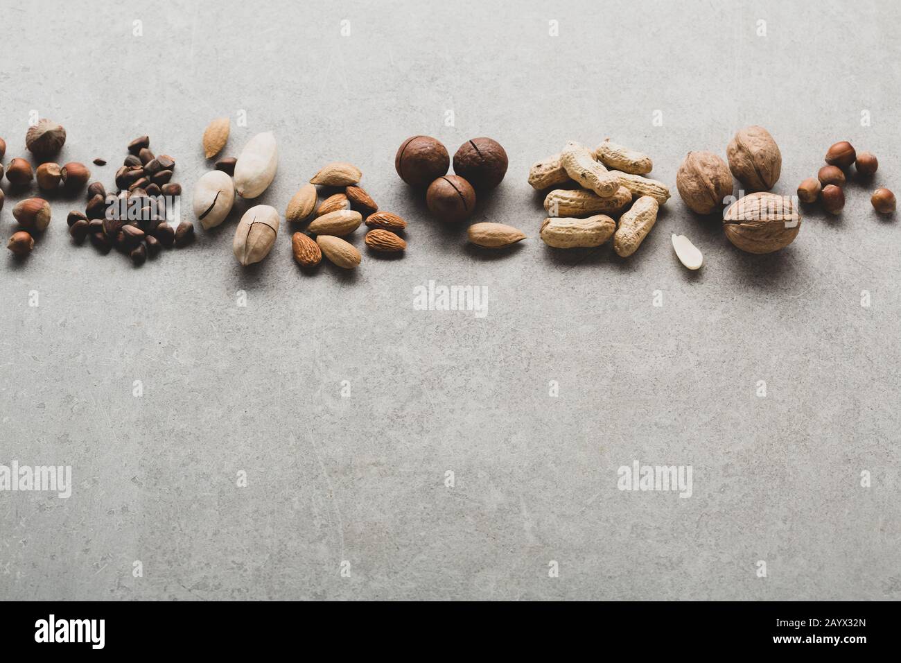 Pine nuts and pecan on gray background, healthy nuts Stock Photo