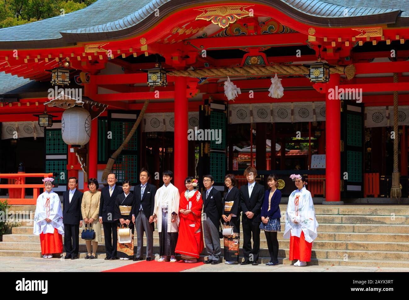 KOBE, JAPAN, April 06, 2019 : Celebration of a traditional Japanese wedding with all the family posing in front of the Ikuta-jinja shrine, Kobe. Stock Photo